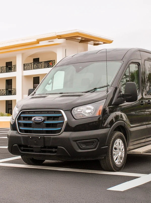 black passenger bus parked in front of a hotel